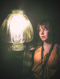 Girl looking into lamp