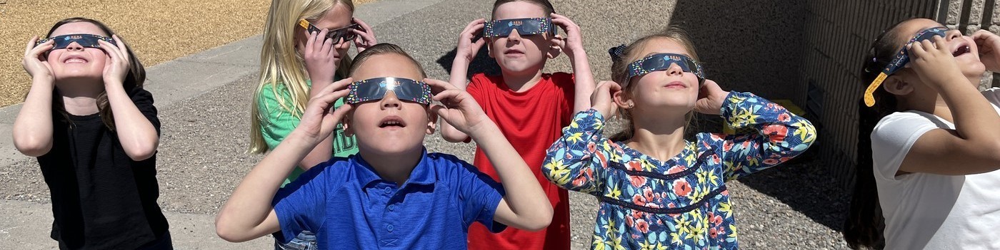 Oak Grove Elementary kids watching eclipse with glasses picture one