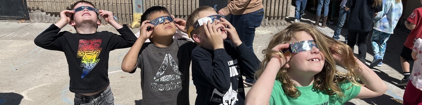 Oak Grove Elementary kids watching eclipse with glasses picture two
