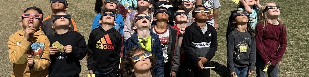 Pomona Elementary kids watching eclipse with glasses picture one