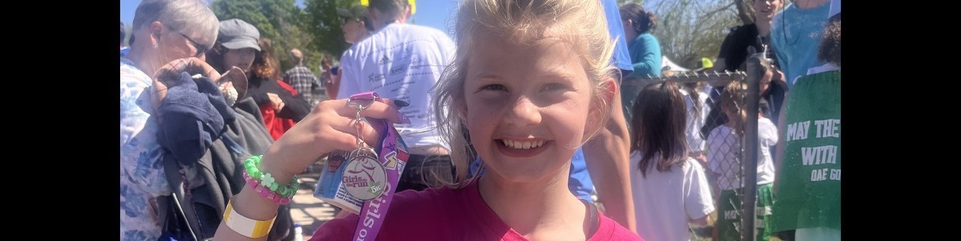 Pomona Elementary Girls on the Runner kid with her medal 2024