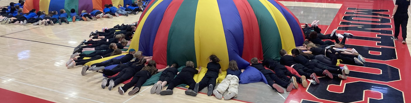 Kids with parachutes at montrose high school during fourth grade showcase