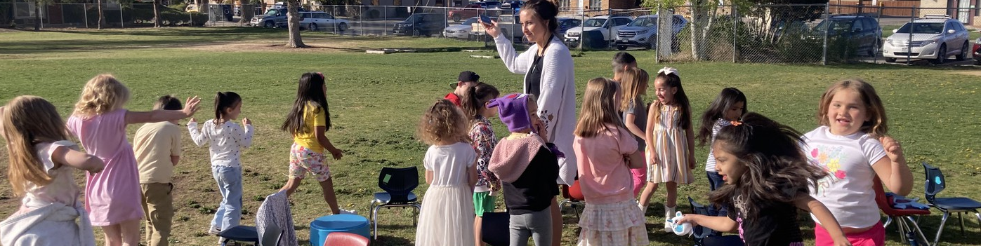 Pomona Kids playing musical chairs in grass